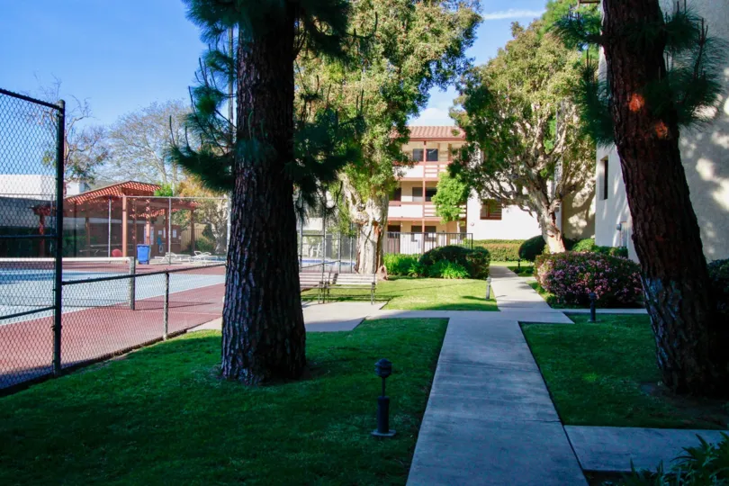 Community tennis courts and walkway in the Newman Terrace community located in Huntington Beach, CA