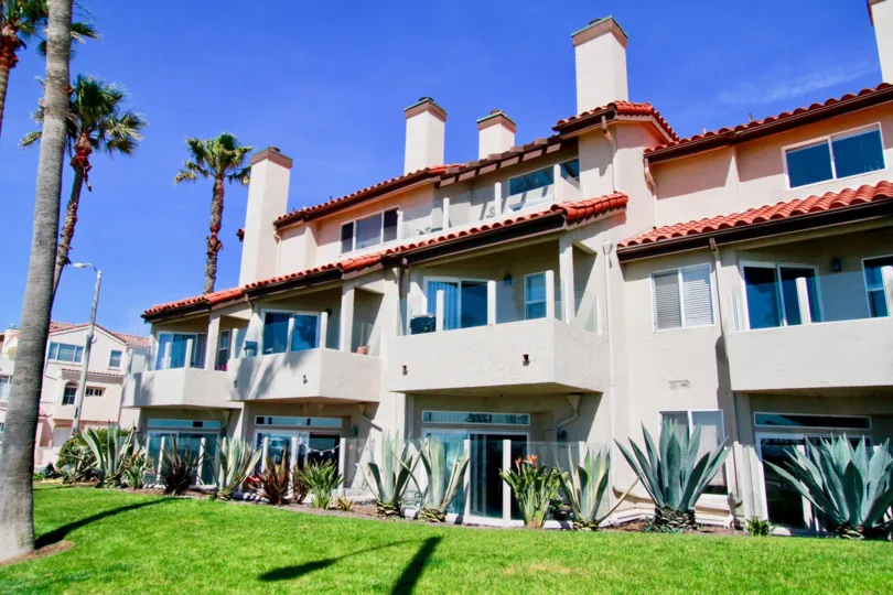 Nice view of lawn with villas and palm trees around in Ocean Breeze of Huntington Beach