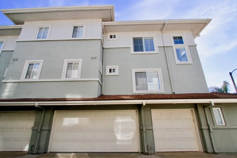 Pacific Park Villas apartment building with garages on a sunny day.