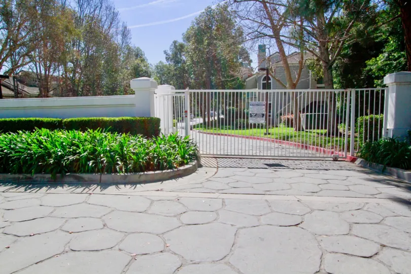 Gated residential community with well kept landscaping on a sunny and beautiful day in Huntington Beach California