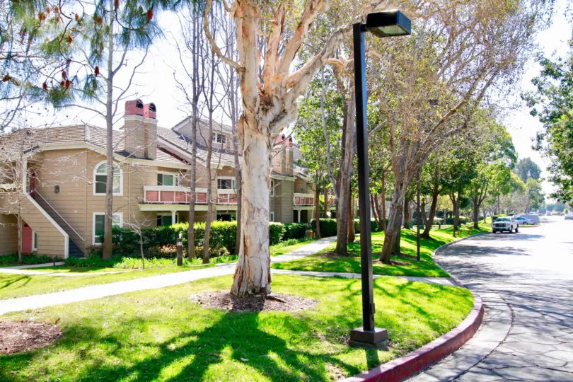 THE BUNGALOW WITH SMALL GARDENS IN FRONT OF THE PLACE AND A ROAD ALSO AVAILABLE CAR CAN MOVING ON THE ROAD A NIGHT LAMP ALSO NEAR TO THE ROAD.