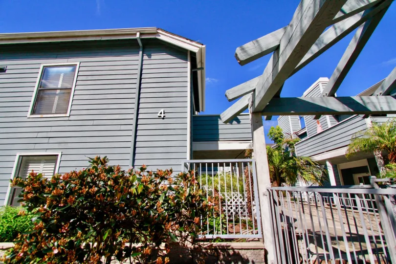 Pelican Cove building with a balcony on a sunny day.