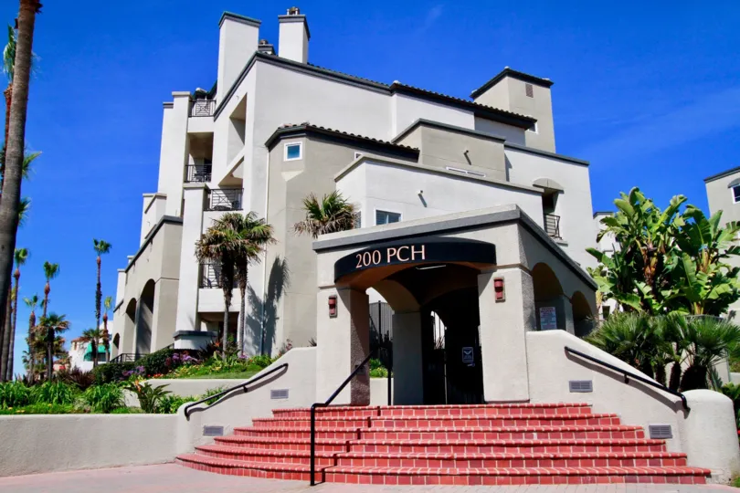 The entrance of a condominiums unit located on highway 101 on a sunny day in Huntington Beach California