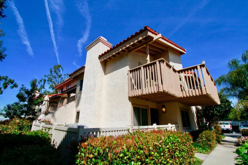 THE BUILDING WITH BALCONY AND A GOOD LOOKING ROOF AND SOME GARDEN ALSO NEAR TO THE BUILDING.