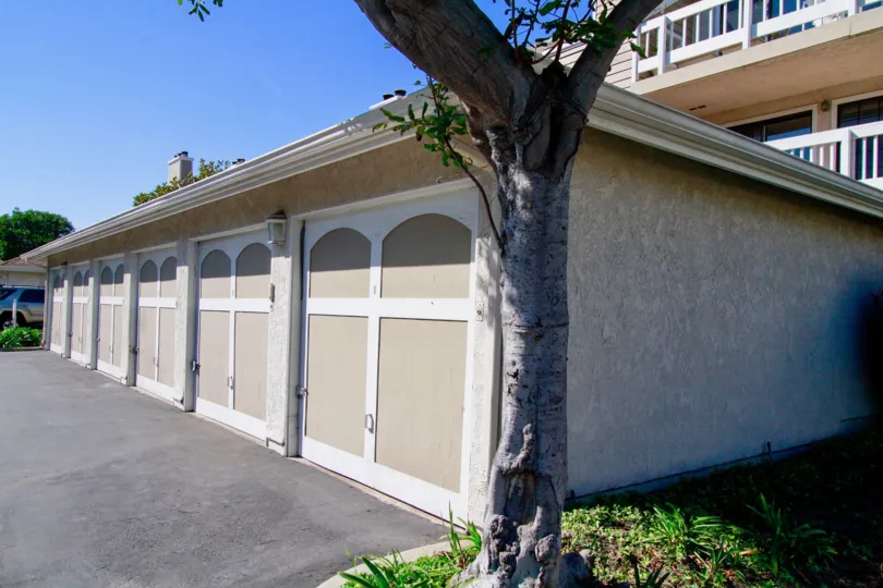 Pointe Surfside garage with a tree on a sunny day.