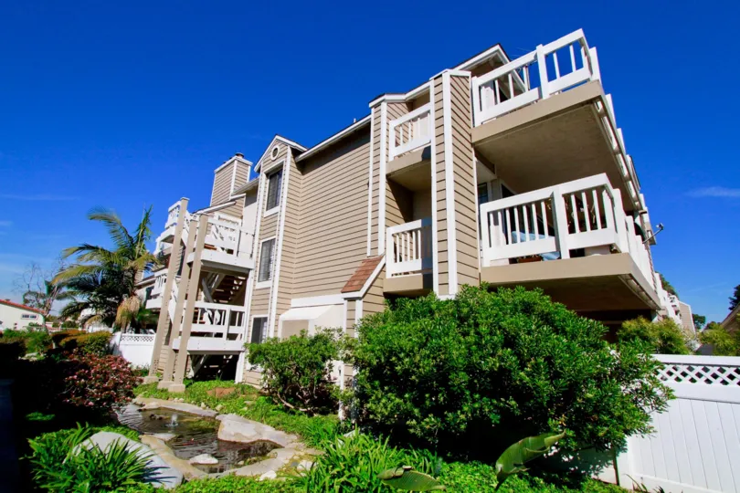 Pointe Surfside apartments with trees and balconies of a sunny day.