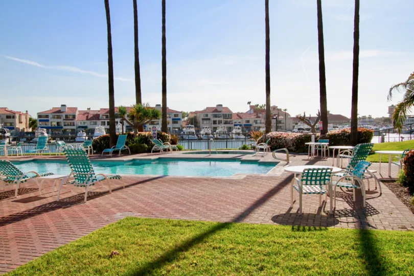 the portofino cove has a swimming pool with long and height trees in it is in califirnia