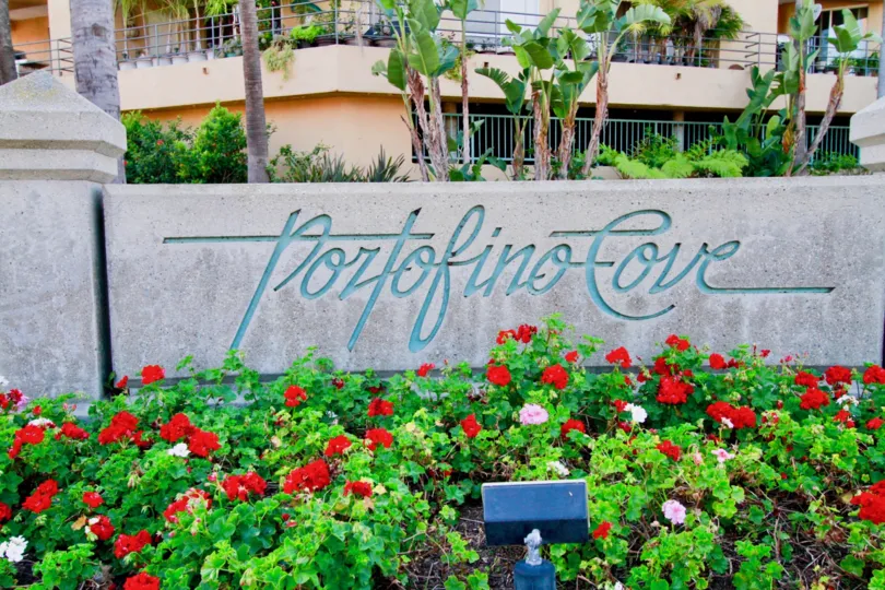 Lovely flower garden with name board with trees near villa of Portofino Cove of Huntington Beach