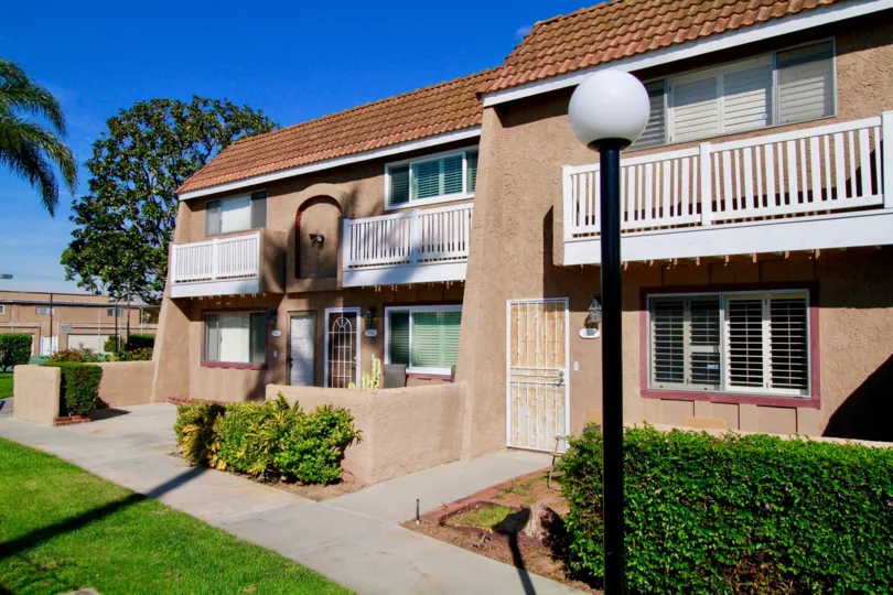 Riviera Huntington apartments with bushes and lamp post.