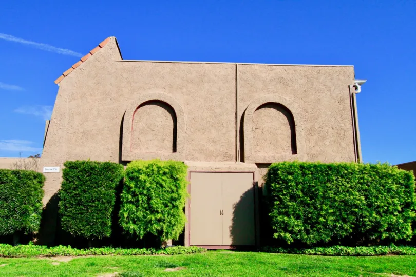 A sideview of a tan building located in the Riviera Huntington community.