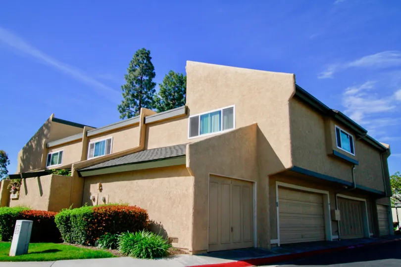 THE HOUSE WITH FLOORS AND MORE WINDOWS WITH GLASSES AND ALL CLOSED SOME GARDENS ALSO NEAR TO THE HOUSE AND A TREE WITH GOOD HEIGHT AT THE BACKSIDE OF THE BUILDING.