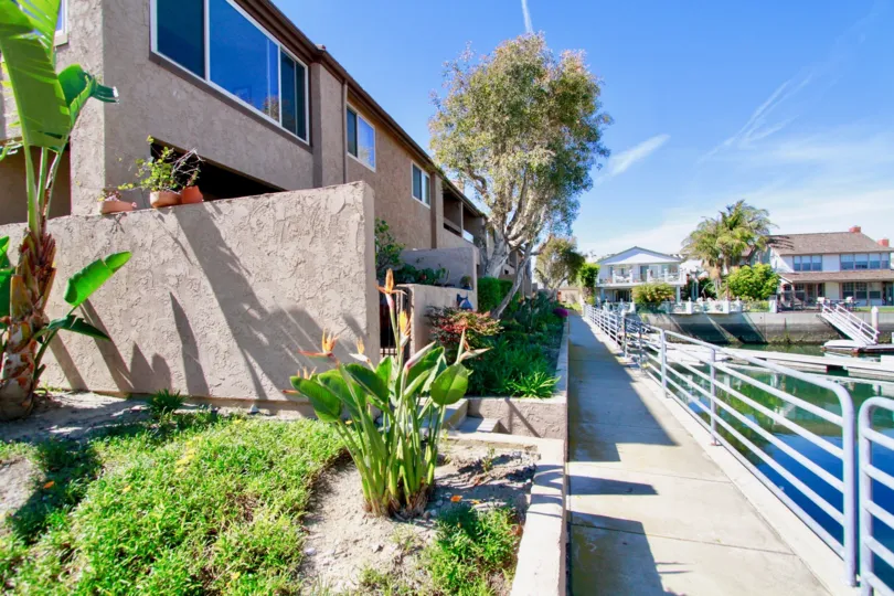 Sea Harbou Huntington Beach California building shape very long ground and top floor attached light biscuts paint window glass attached house near to water place and steps attached