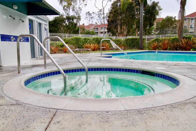 A round hot tub and rectangle pool sit inside the Seabridge Townhomes in Huntington Beach CA
