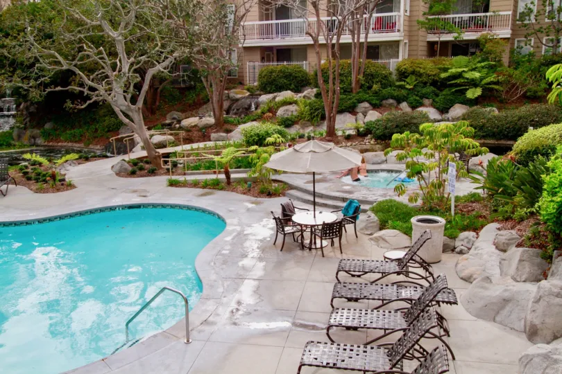 A clear pool surrounded by gardens at the Seabridge Villas