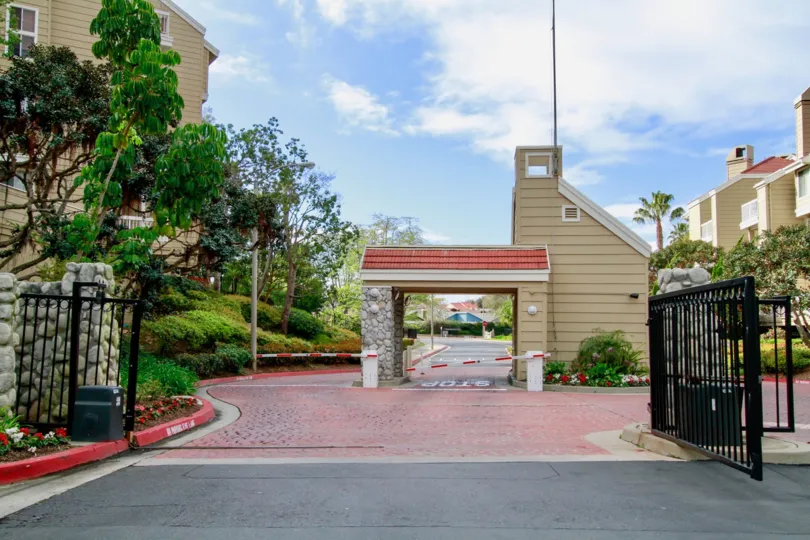 Seabridge Villas gate with a guard building and trees on a cloudy day.