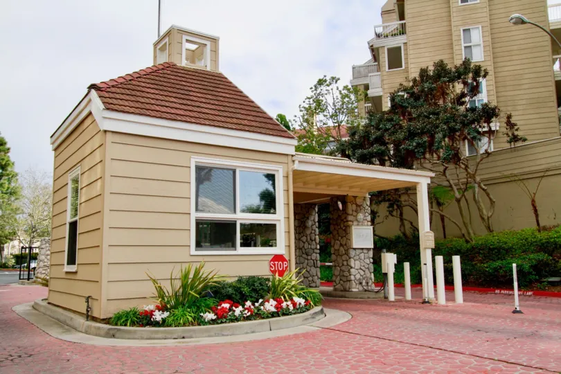 Seabridge Villas security building with a stop sign on a cloudy day.