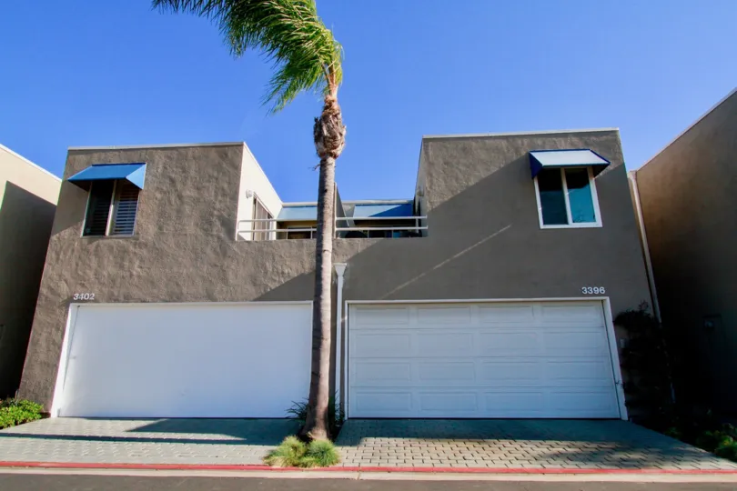 Seabridge building with a garage and a balcony of a sunny day.