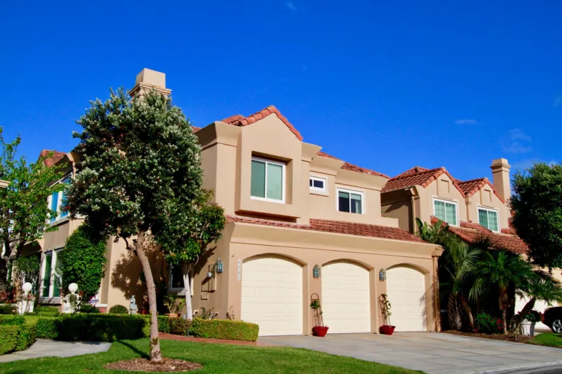 Seacliff on the Greens two story building with three garages on a sunny day.