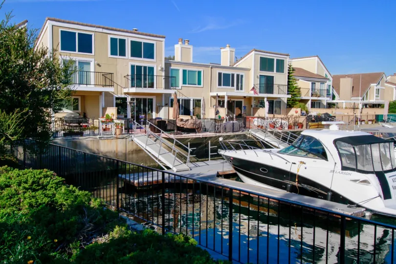 Town homes painted light brown with their own private marina and dock. Located in Huntington Beach California.