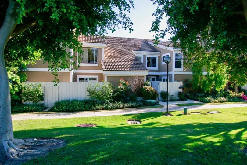 Town homes with ceramic tile roofing and shady trees in the Seagate community of Huntington Beach.