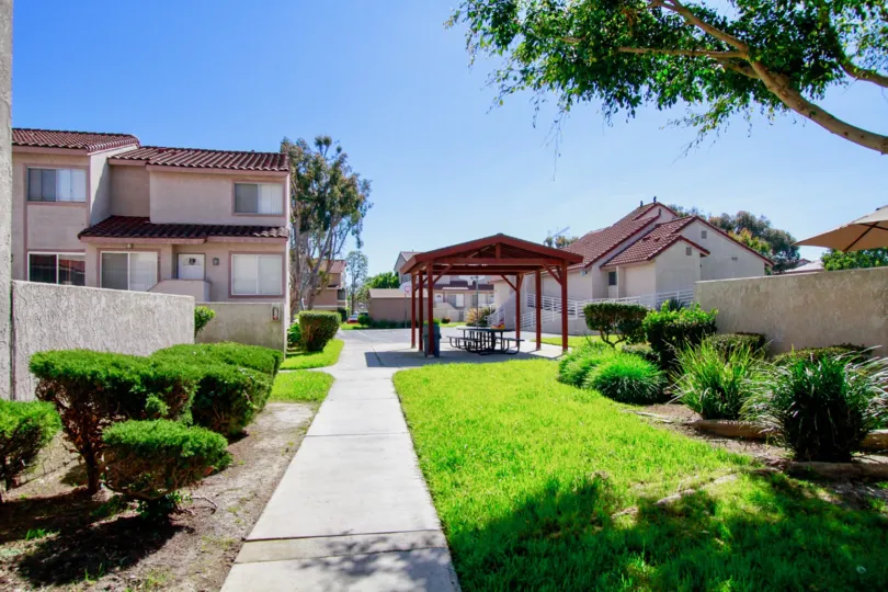 A HOUSE WITH GUEST ROOM AND SITTING PLACE SOME GRASS ALSO BOTH SIDE AND TREES ALSO AVAILABLE AT THE MORNING TIME