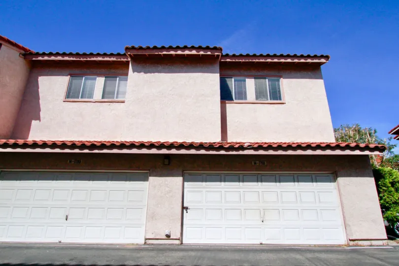the side of a townhome at Seaside Village including a side window and garage.