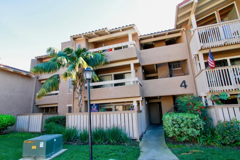 Seaspray apartments with a flag and balconies on a sunny day.
