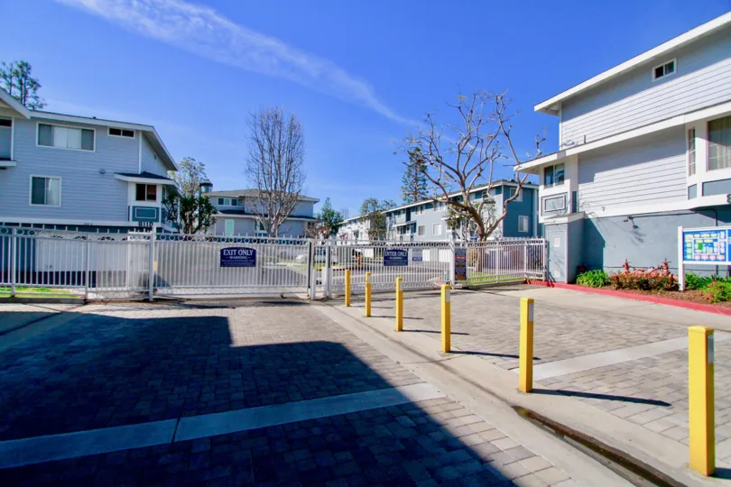 Entrance to Seawind Cove community with a gate on a sunny day.