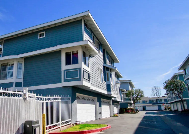 Seawind Cove street with homes on either side on a sunny day.