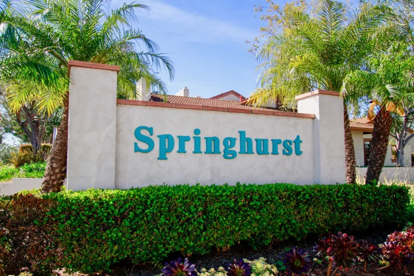 Springhurst Huntington Beach California building not viewcover for the name sign light rose color paint front big tree attached view to sky name board letter blue color