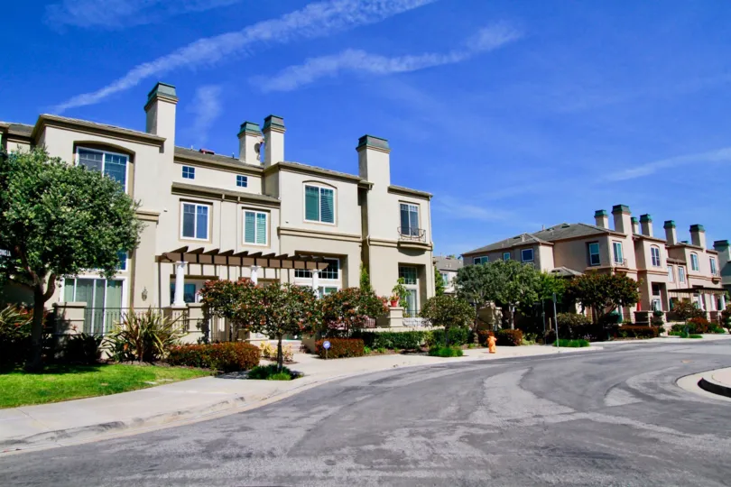 A huge building in the Surfcrest with clean street road and trees and also with plants.
