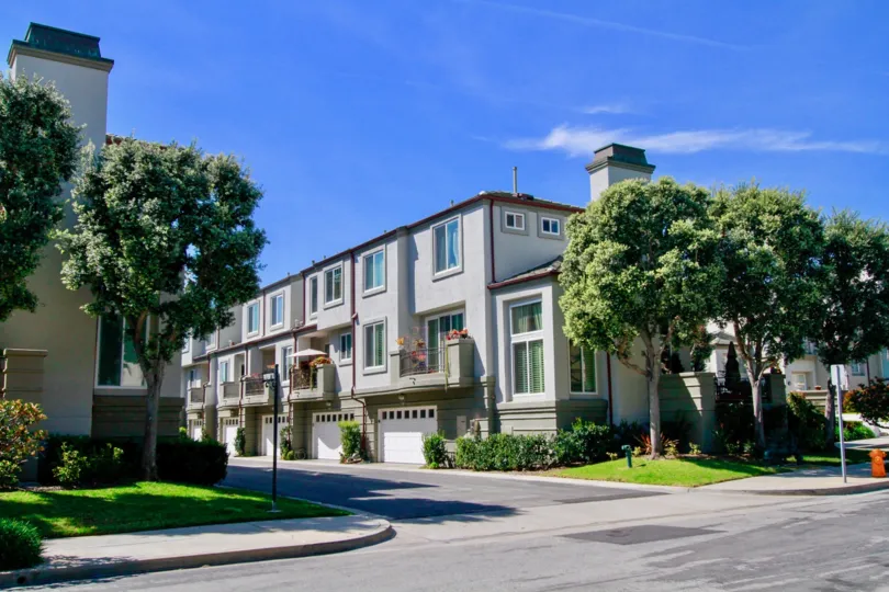 A sunny day in the Surfcrest with clean street road and aslo with trees, lawn, and plants.