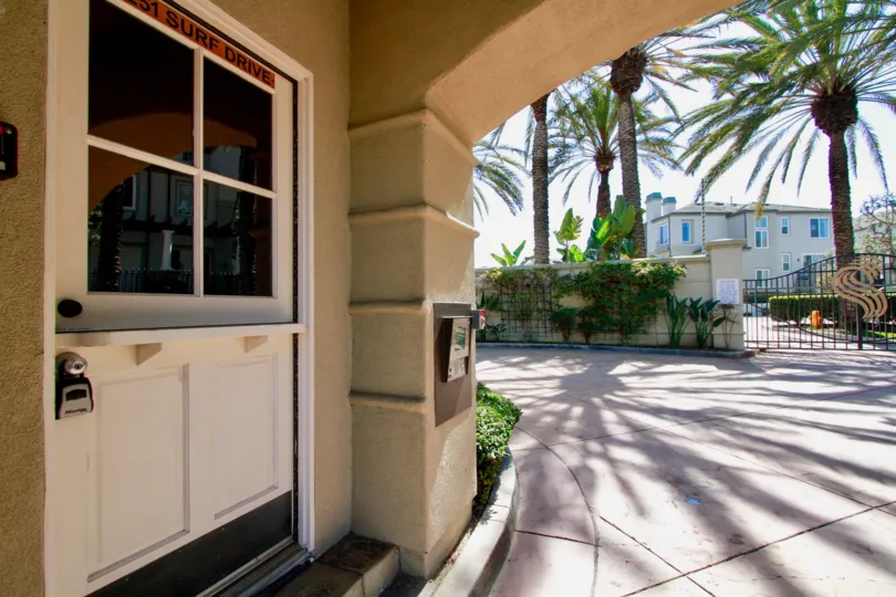 Surfcrest Huntington Beach California building color light biscuts color front door only view glass attached news paper box attaced