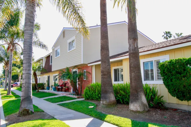 A HOUSE WITH BEAUTIFUL GRASS IN FRONT OF THE PLACE AND MORE TREES ALSO AVAILABLE THE HOUSE ALSO DESIGN WITH MILD COLOUR.