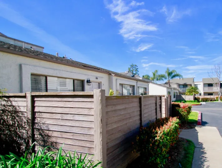 Fencing protects the front lawn of a beautiful home at Tamarack Village, Huntington Beach, California.