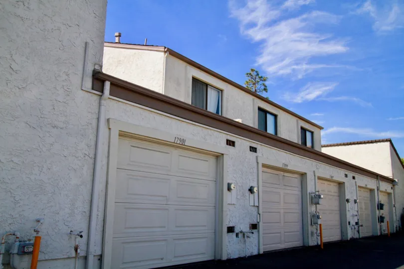 Row of Tamarack Village garages with apartments above on a sunny day.