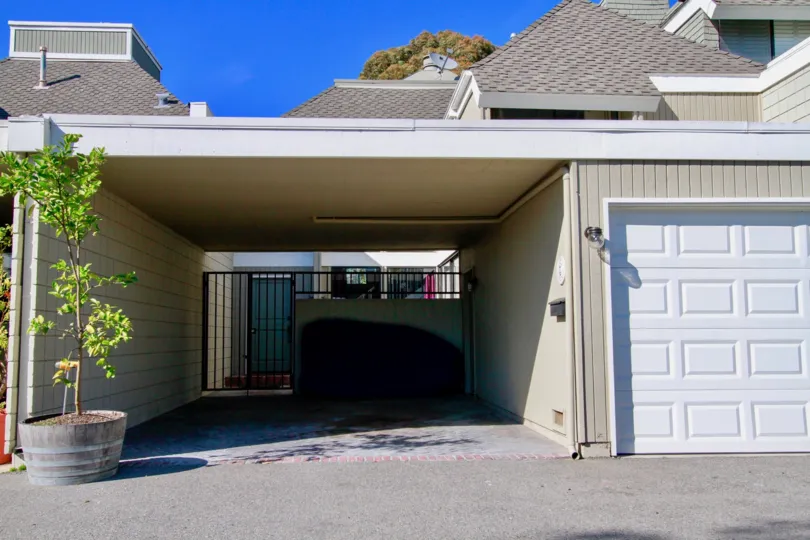 Villa Pacifica Huntington Beach California building light gray color paint front small tree big steel door attached view to sky
