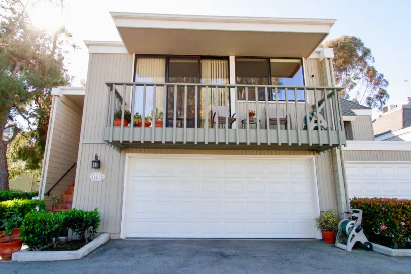 Tennis Estates Huntington Beach California building shape box type top floor balcony attached ang glasses left side stepsback sidebig tree wall light attached