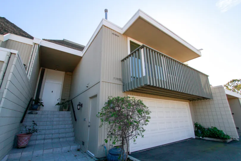 the simple home with lot of steps and a balcony which is suitated in tennis estate of huntington beach, california