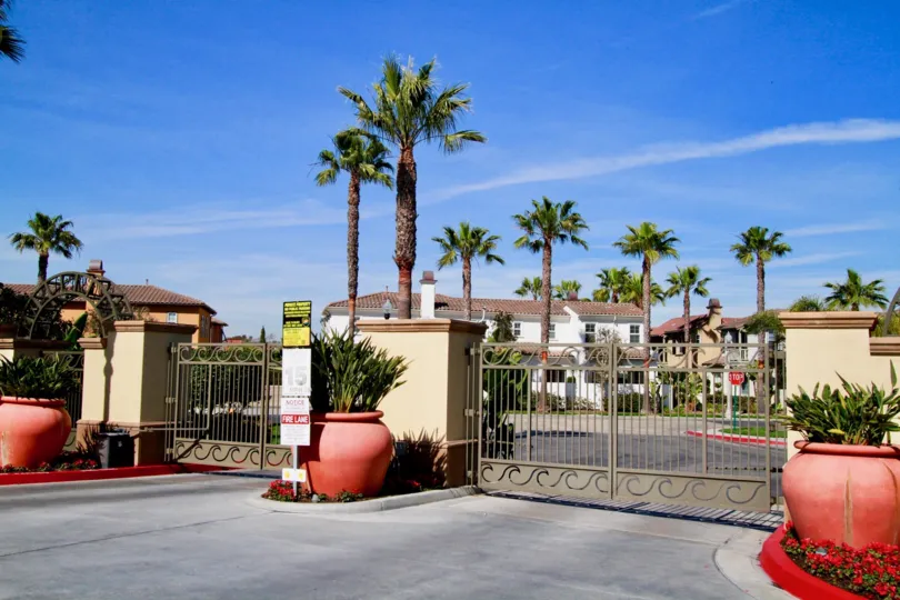 The Waterfront gates with big potted plants in front.
