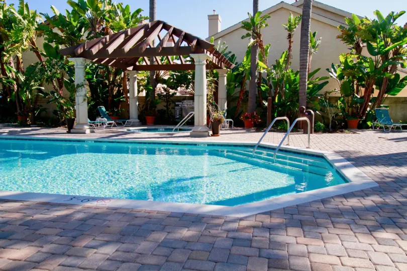 Awesome looking swimming pool with plants and protigos in Tiara De La Pacifica of Huntington Beach