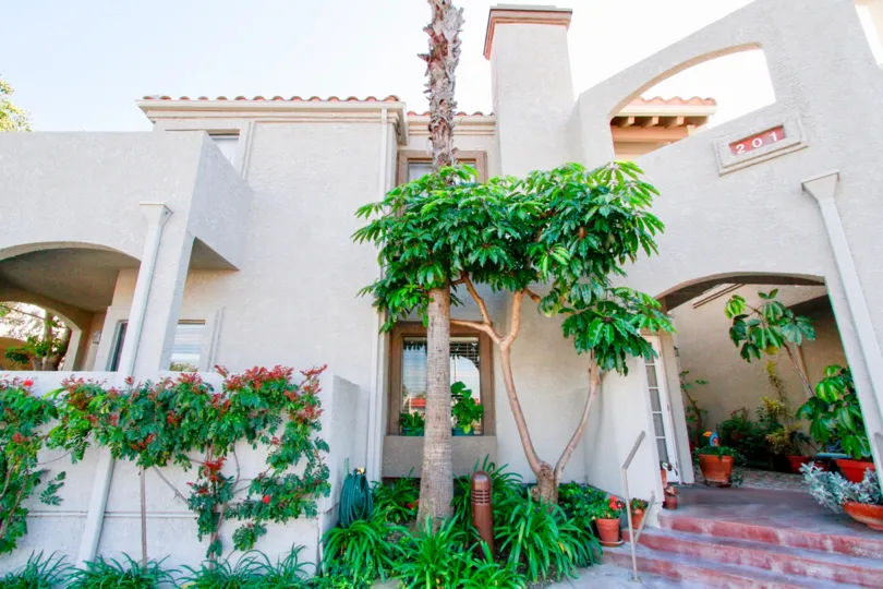 Nice entrance view of a villa with number and small trees around in Tiara De La Pacifica of Huntington Beach