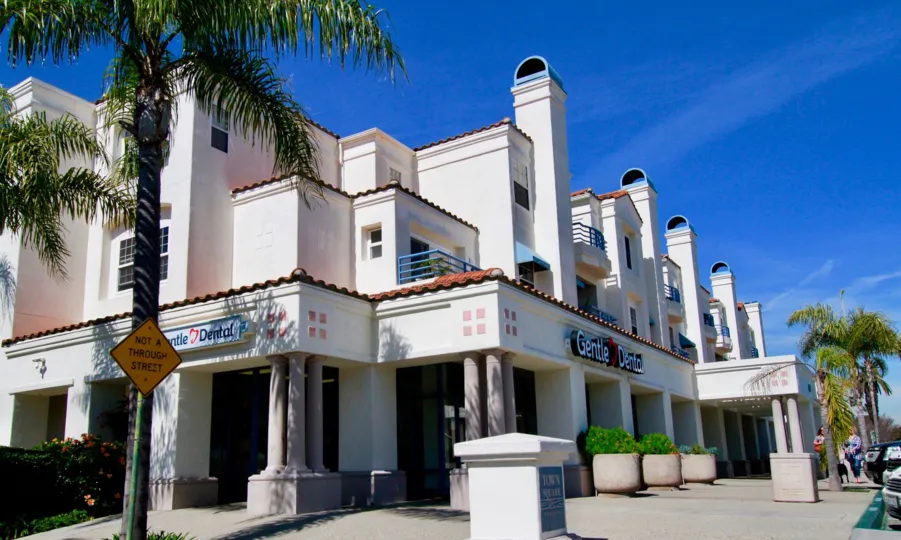 Fabulous outer view of villas with display boards and palm trees around in Townsquare Codos of Huntington Beach