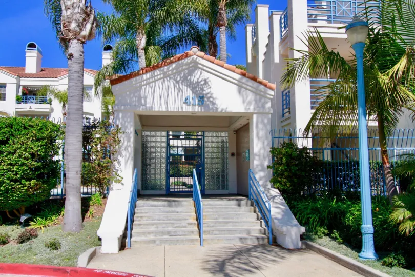 THE HOUSE WITH IN AND OUT ENTRANCE AND IT LOOKS BEAUTIFUL AND STEPS ALSO AVAILABLE AT THE FRONT A LAMP AND SOME PLANTS NEAR TO THE BUILDING.