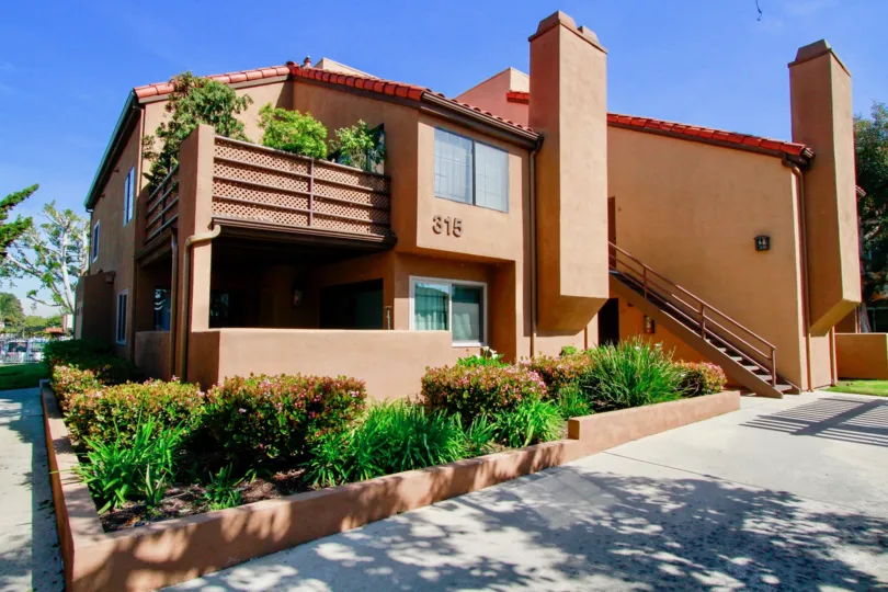 the home in pink colour has a grden in its terrace which is in villa st. croix of huntington beach, california