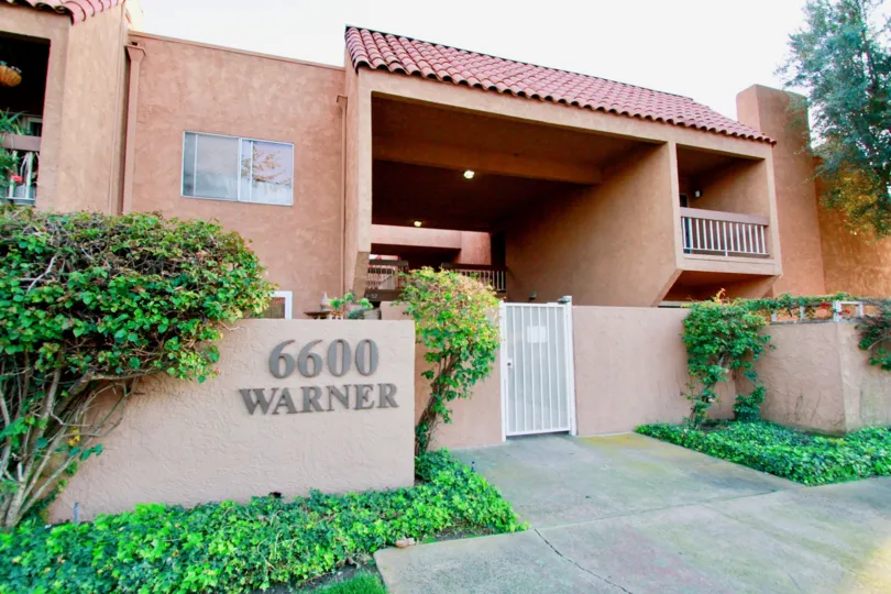 Villa Warner Huntington Beach California building color brown paint balcony gate attached wall light attached name sign board attached