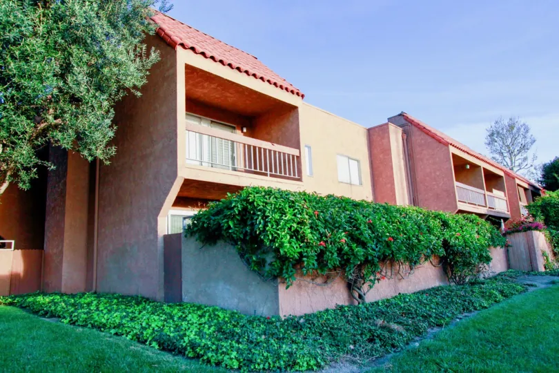 Villa Warner Huntington Beach California building is rose color paint and glass window and balcony attached