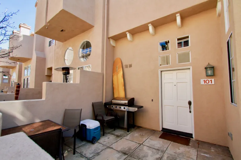 Villas at Huntington Huntington Beach California building is brown paint and light door bench chair attached