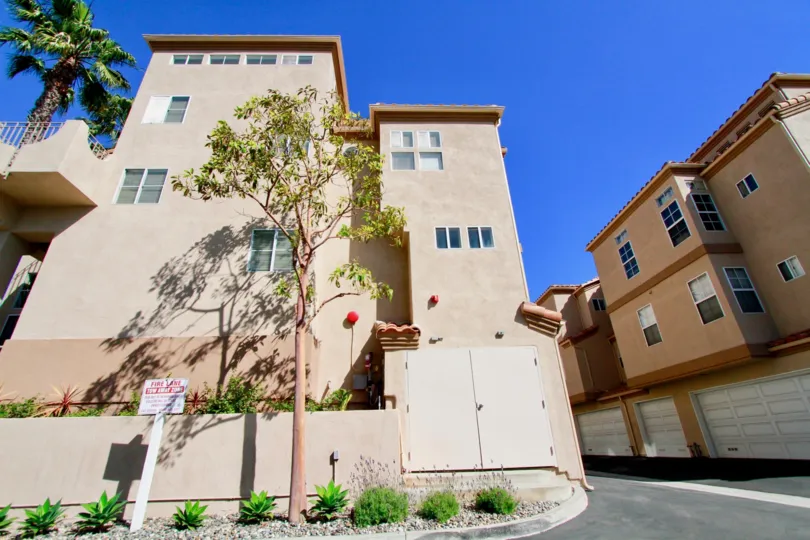 Villas at Huntington Beach Huntington Beach California building is biscuts color paint and glass window attached back side tree walk place very need