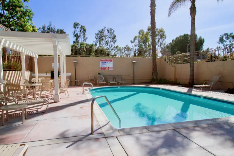 Villas at Huntington Beach Huntington Beach California building shape not view balcony and swimming pool bed attached clear sky view house near to big tree